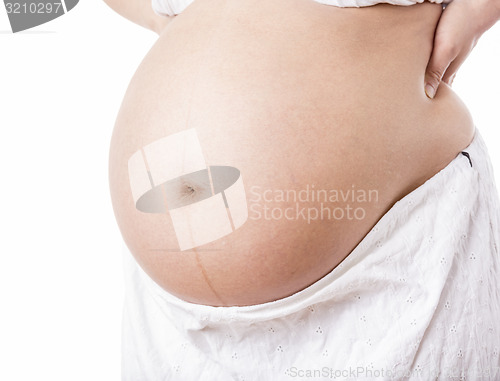 Image of Naked Pregnant Belly Isolated On White Background