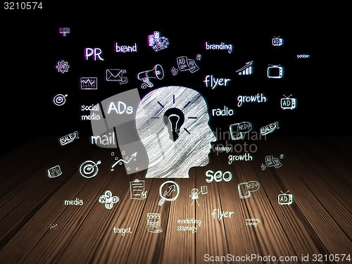 Image of Advertising concept: Head With Light Bulb in grunge dark room