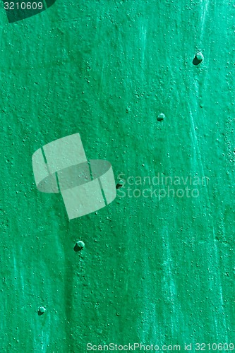 Image of Green painted metal sheet with rivets diagonally