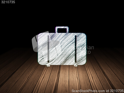 Image of Vacation concept: Bag in grunge dark room
