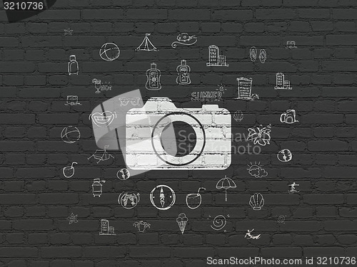 Image of Tourism concept: Photo Camera on wall background
