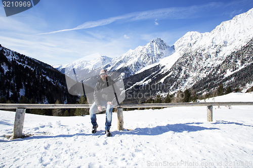 Image of Young man enjoys winter landscape 