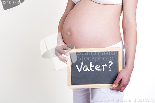 Image of Pregnant woman with German word father on blackboard