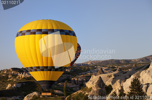 Image of Hot air balloons in mountains at morning