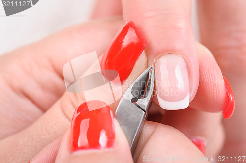 Image of manicure applying - cutting the cuticle 