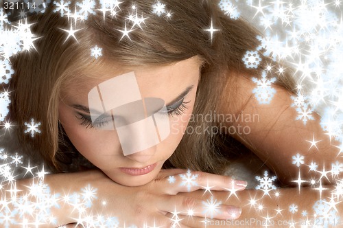 Image of thoughtful girl with snowflakes