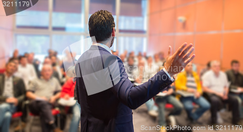 Image of Speaker at Business Conference and Presentation.