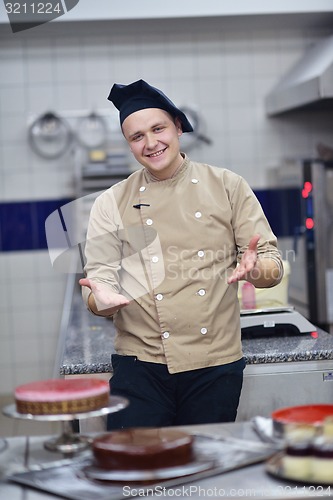 Image of chef preparing desert cake in the kitchen