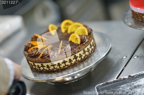 Image of chef preparing desert cake in the kitchen