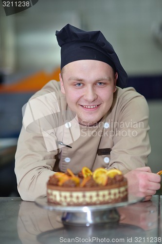 Image of chef preparing desert cake in the kitchen