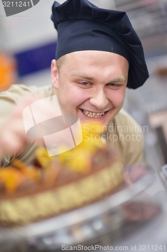 Image of chef preparing desert cake in the kitchen