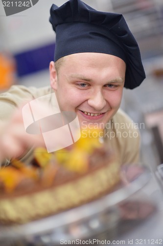 Image of chef preparing desert cake in the kitchen