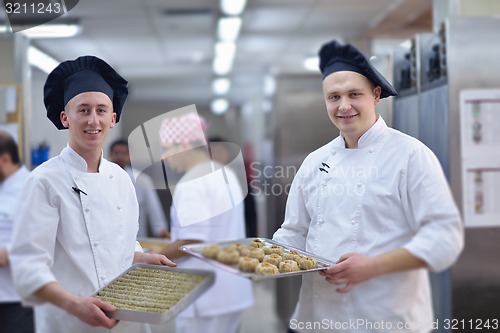 Image of chef preparing desert cake in the kitchen