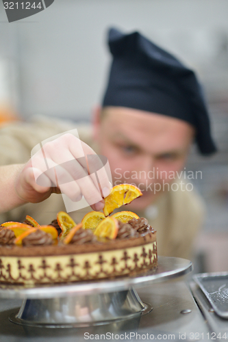 Image of chef preparing desert cake in the kitchen