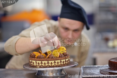 Image of chef preparing desert cake in the kitchen