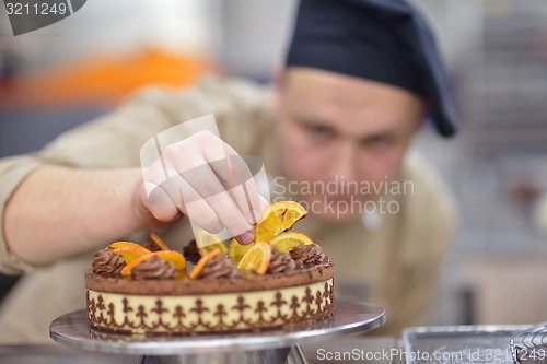 Image of chef preparing desert cake in the kitchen