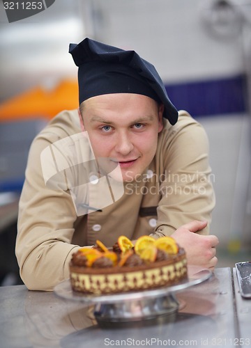 Image of chef preparing desert cake in the kitchen