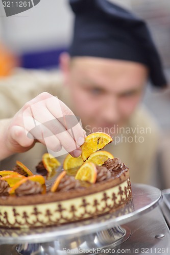 Image of chef preparing desert cake in the kitchen