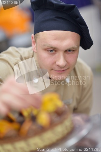 Image of chef preparing desert cake in the kitchen