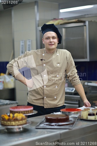 Image of chef preparing desert cake in the kitchen