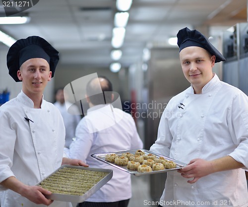 Image of chef preparing desert cake in the kitchen