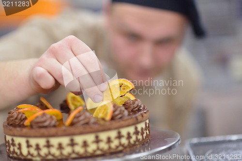 Image of chef preparing desert cake in the kitchen