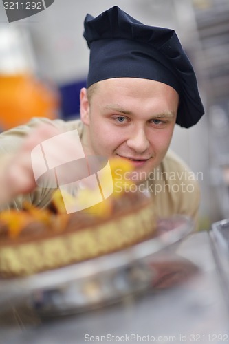 Image of chef preparing desert cake in the kitchen