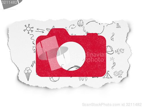 Image of Vacation concept: Photo Camera on Torn Paper background
