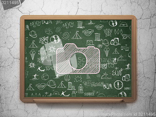 Image of Vacation concept: Photo Camera on School Board background