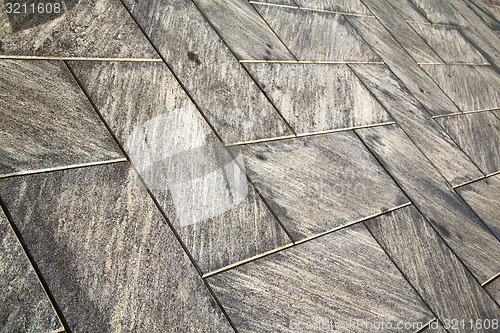 Image of near mozzate street  pavement of a curch and wall marble