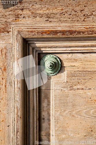 Image of abstract   rusty brass    door curch  closed wood    varese lona