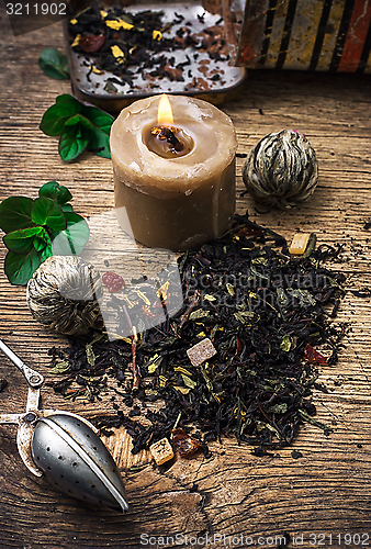 Image of tea brew with lime and mint on wooden background 