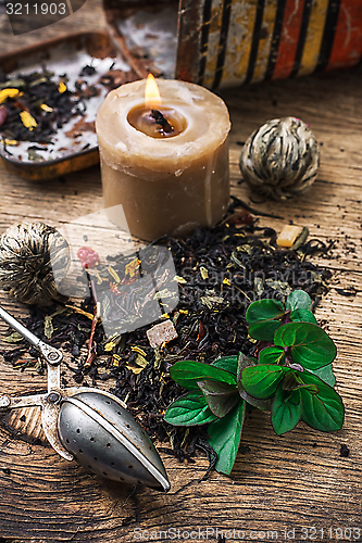 Image of tea brew with lime and mint on wooden background 