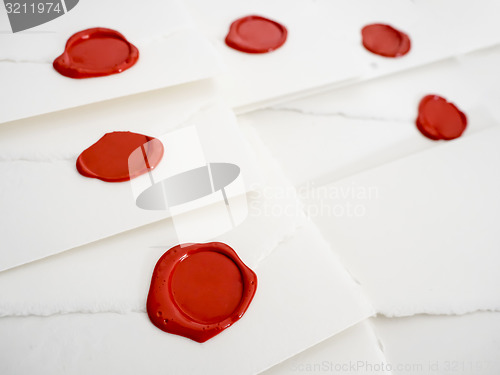 Image of group of white letters with red sealing wax