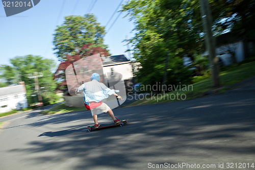 Image of Longboarder Speeding Downhill