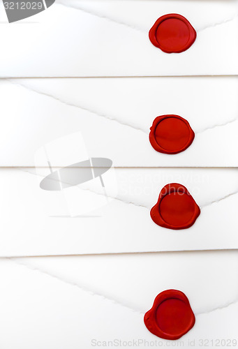 Image of group of white letters with red sealing wax