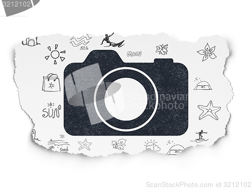 Image of Vacation concept: Photo Camera on Torn Paper background