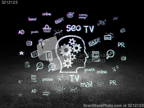 Image of Marketing concept: Head With Gears in grunge dark room