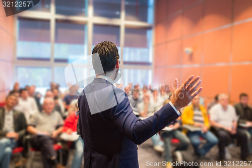 Image of Speaker at Business Conference and Presentation.