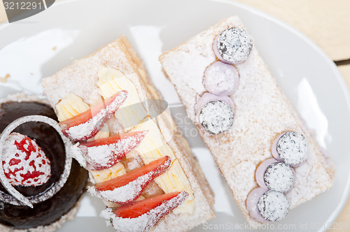 Image of selection of fresh cream cake dessert plate 