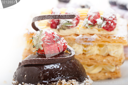 Image of selection of fresh cream cake dessert plate 