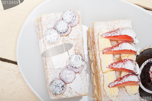 Image of selection of fresh cream cake dessert plate 