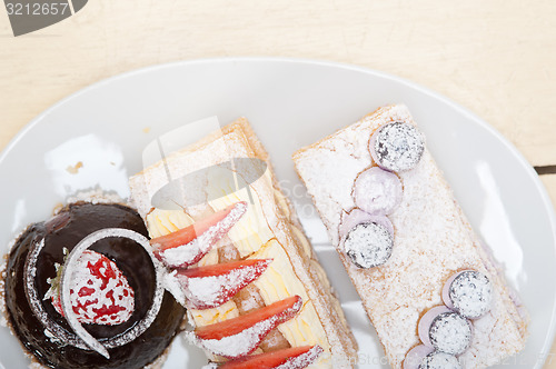 Image of selection of fresh cream cake dessert plate 