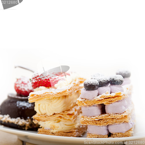 Image of selection of fresh cream cake dessert plate 