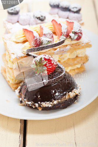 Image of selection of fresh cream cake dessert plate 