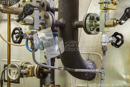 Image of Pipes and faucet valves of heating system in a boiler room