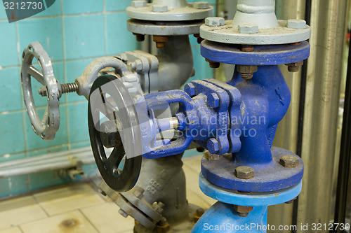 Image of Pipes and faucet valves of heating system in a boiler room