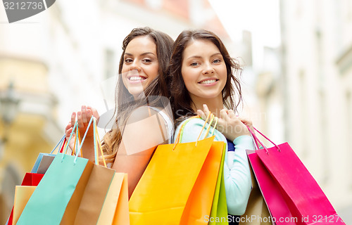 Image of beautiful women with shopping bags in the ctiy