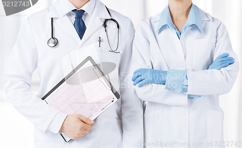 Image of nurse and male doctor holding cardiogram