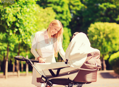 Image of happy mother with stroller in park